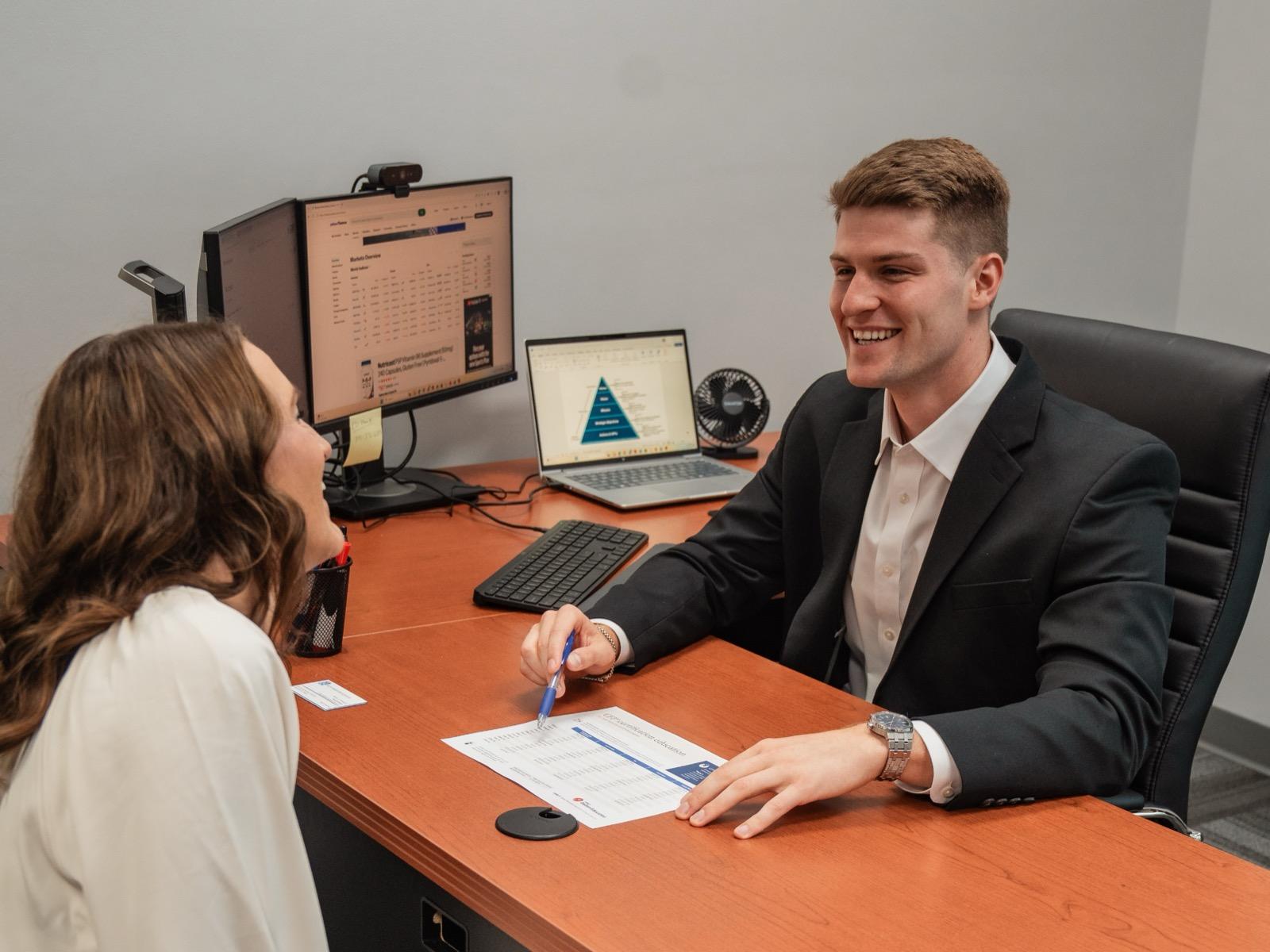 A Faith Investor Services team member meeting with a client