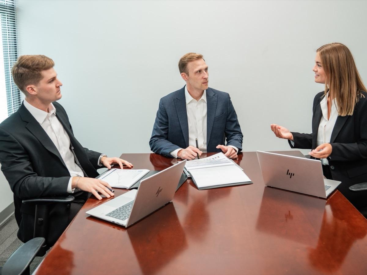 Faith Investor Services colleagues meeting around a conference table