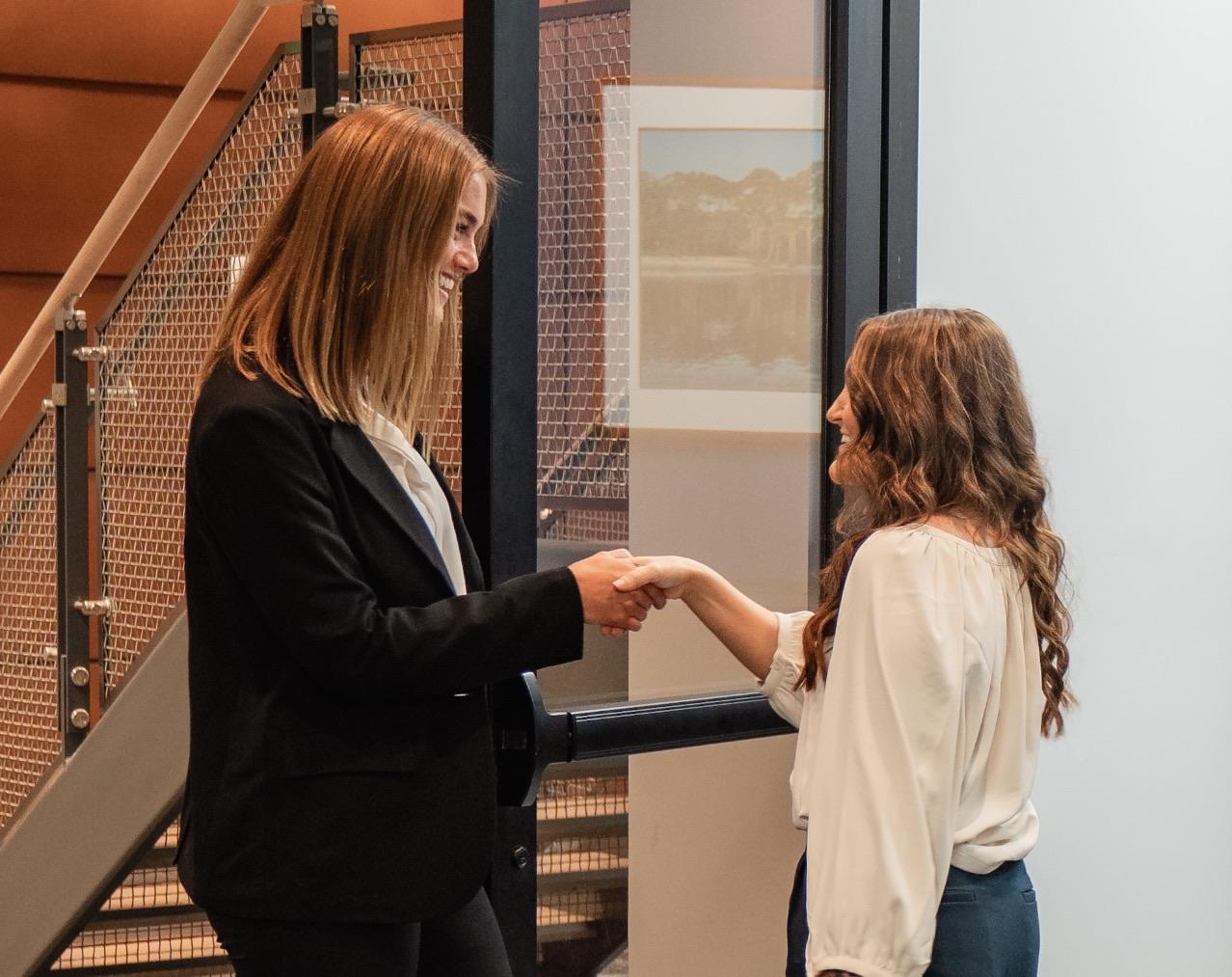 A Faith Investor Services team member greeting a client with a handshake